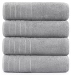 Spa-like experience with a white 600-GSM bath sheet and candles